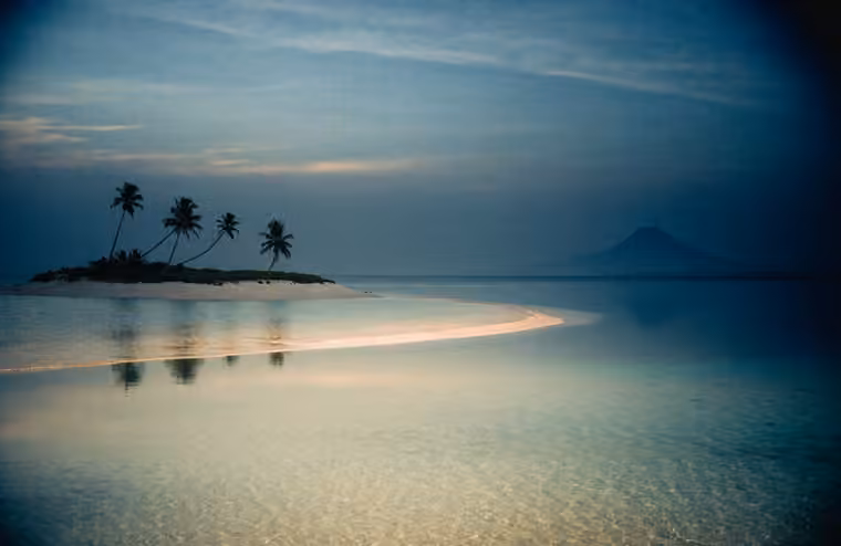 Clear shallow water and a low sandy shoreline in the Gili Islands