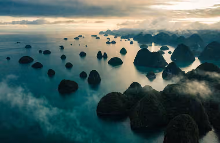 Scattered karst islets in the turquoise shallows of Raja Ampat