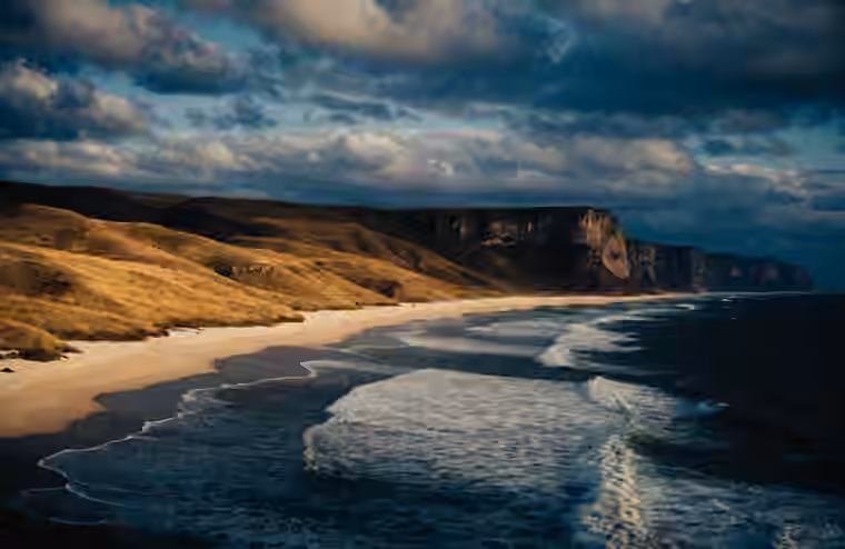 Open savannah hills meeting the sea on Sumba
